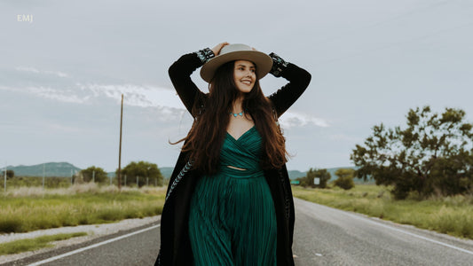 Elisha walking down a road with mountains in the background