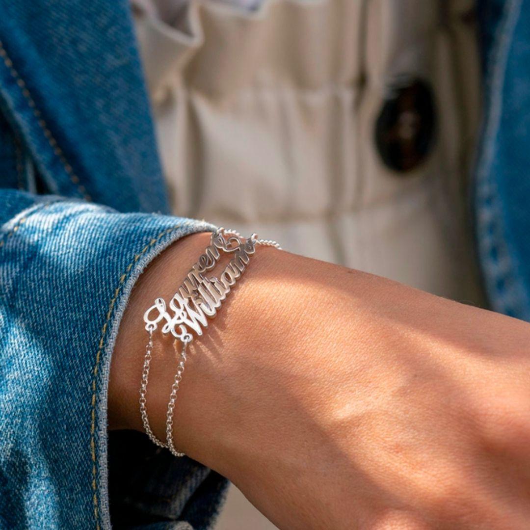 woman in jean jacket wearing silver name bracelets